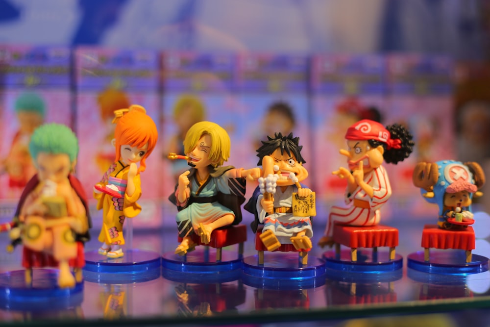 six assorted-color anime character action figures