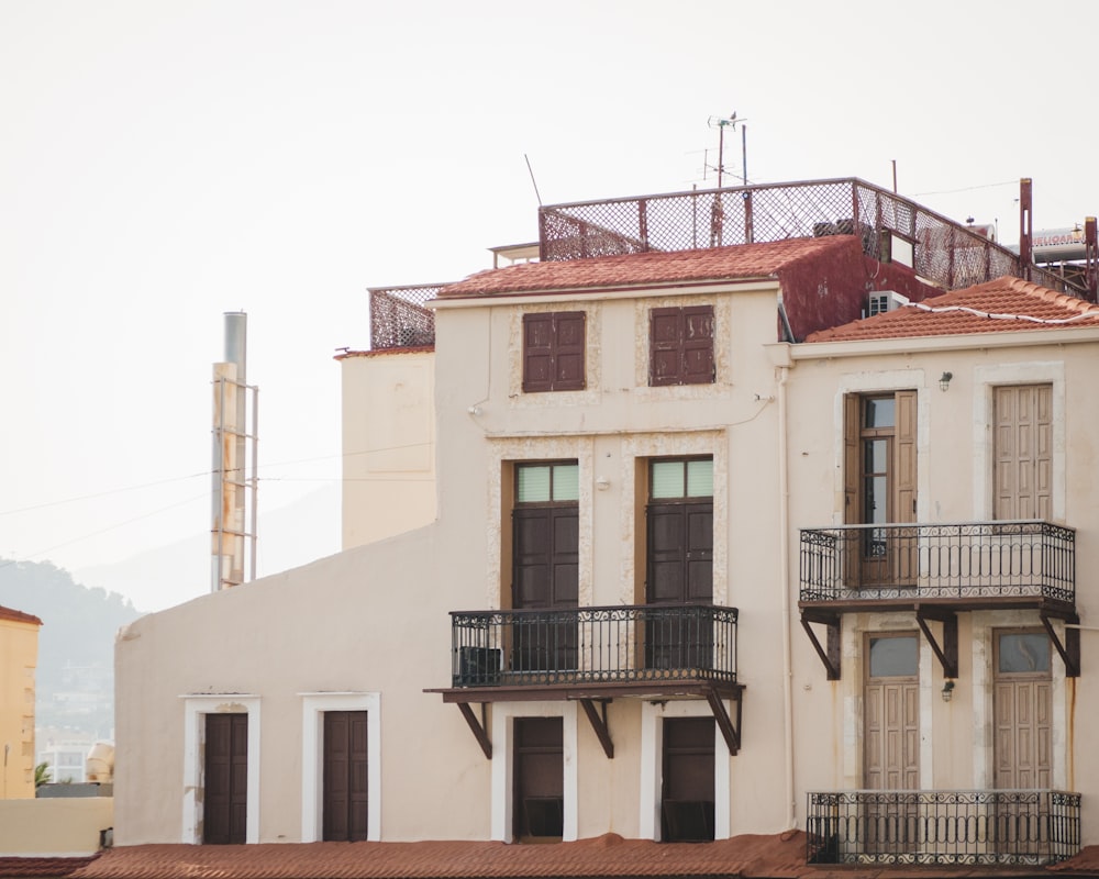 white painted building under white sky