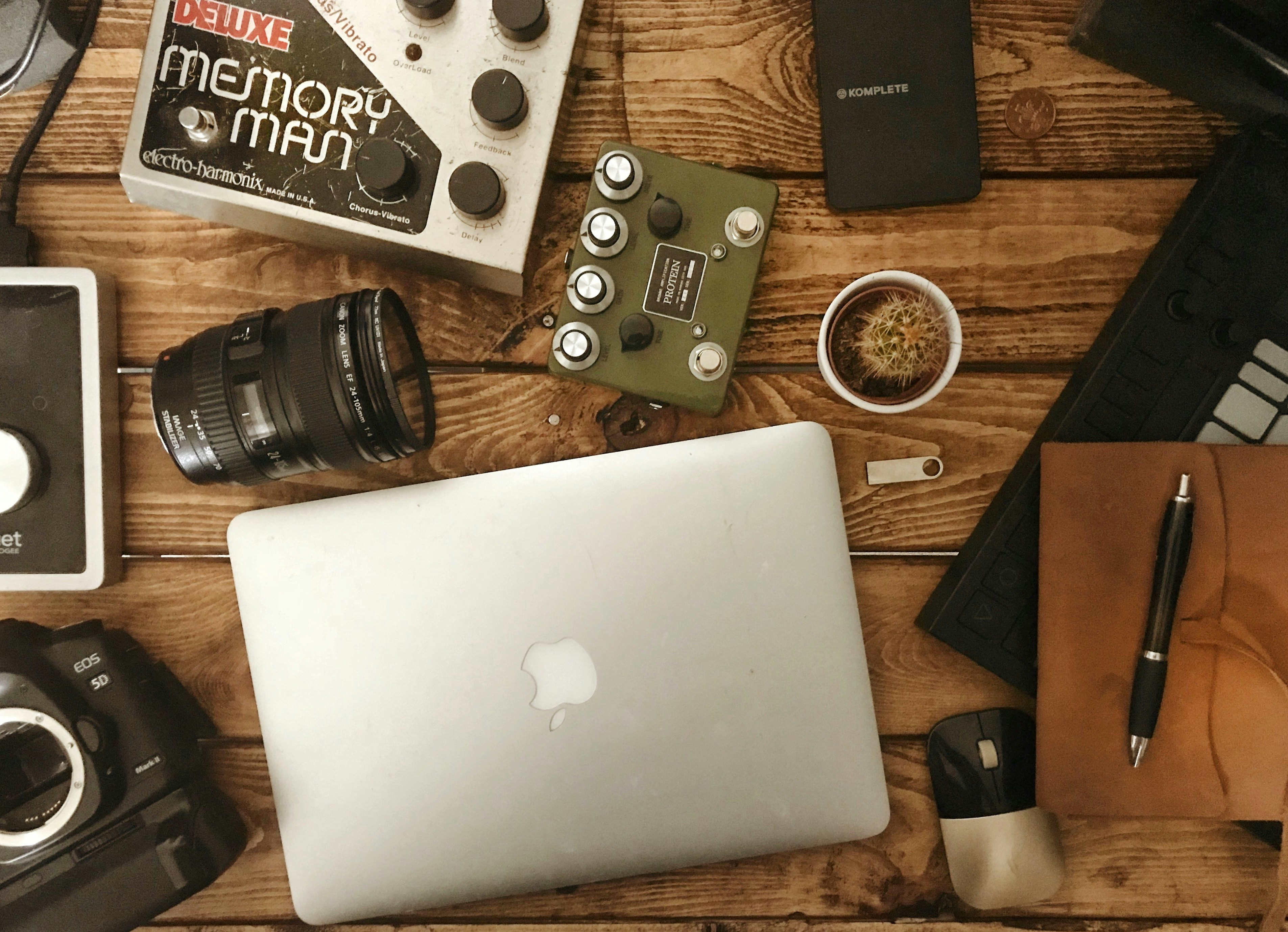 silver MacBook near camera lens