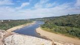 A scenic view of a river flowing through lush landscapes.