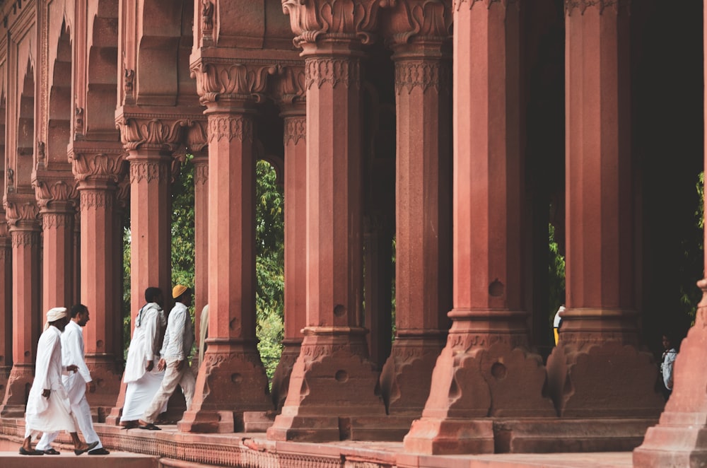 men walking towards establishment with pedestals