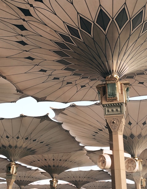 people under pillars with roofs