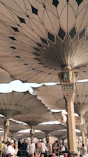 people under pillars with roofs