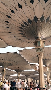 people under pillars with roofs