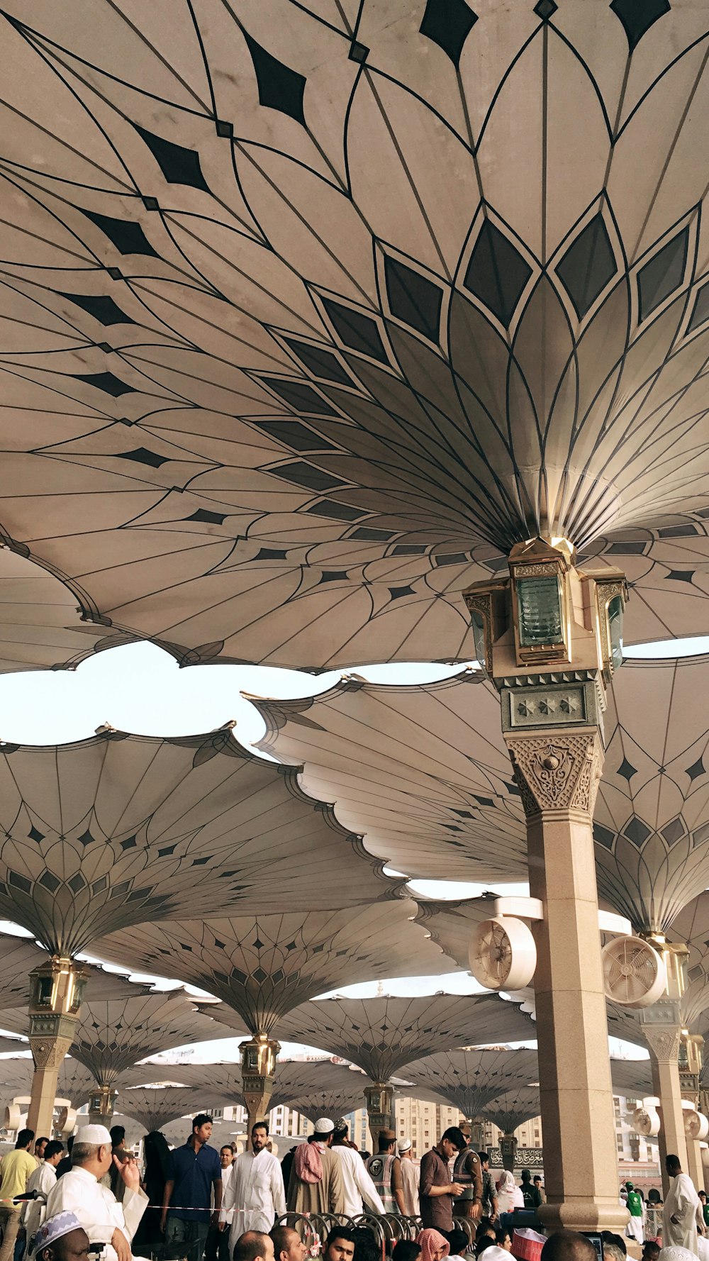 people under pillars with roofs