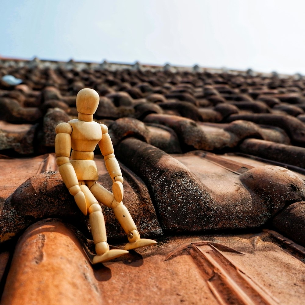 action figure sitting on roof