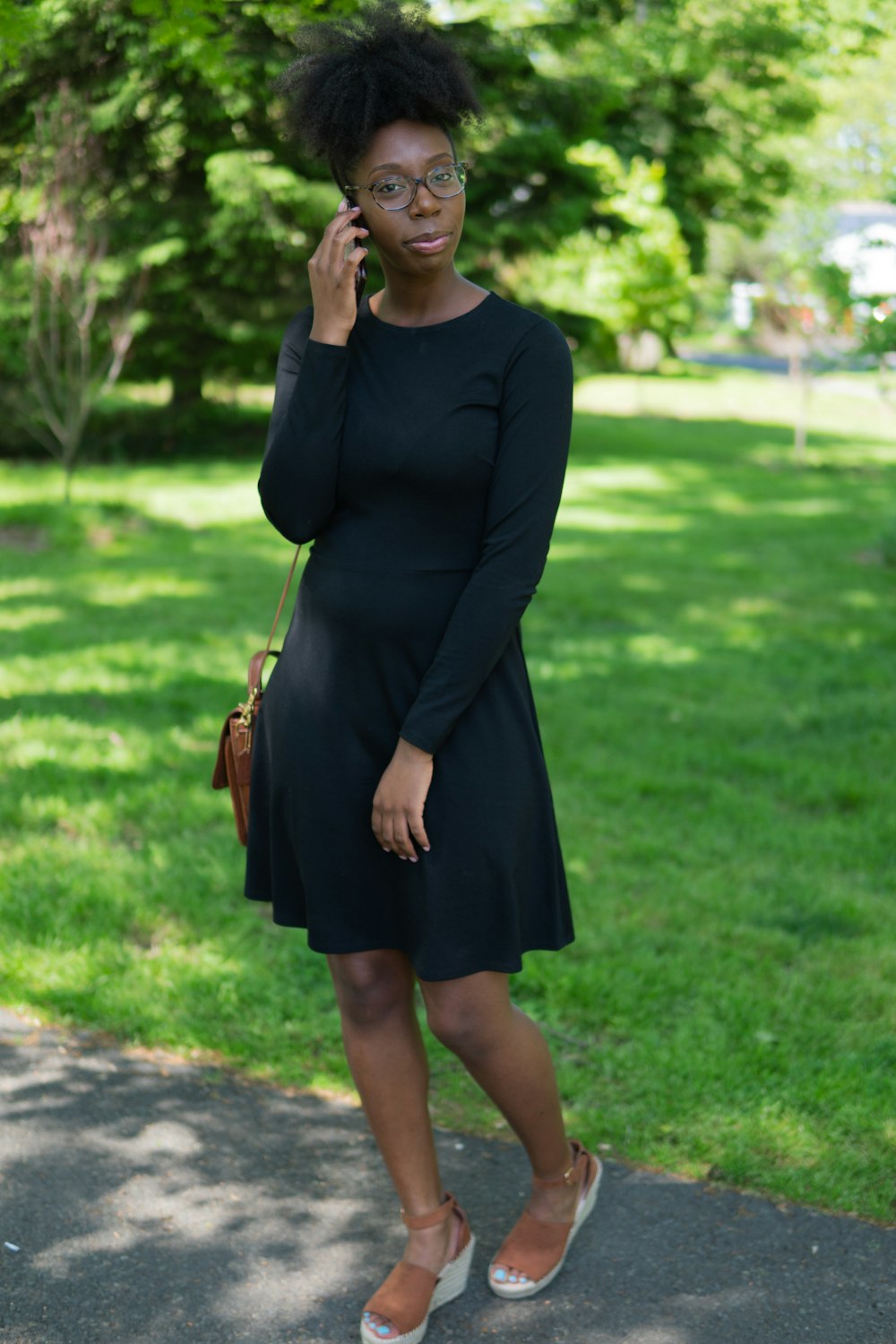 woman in black scoop neck long sleeved midi dress