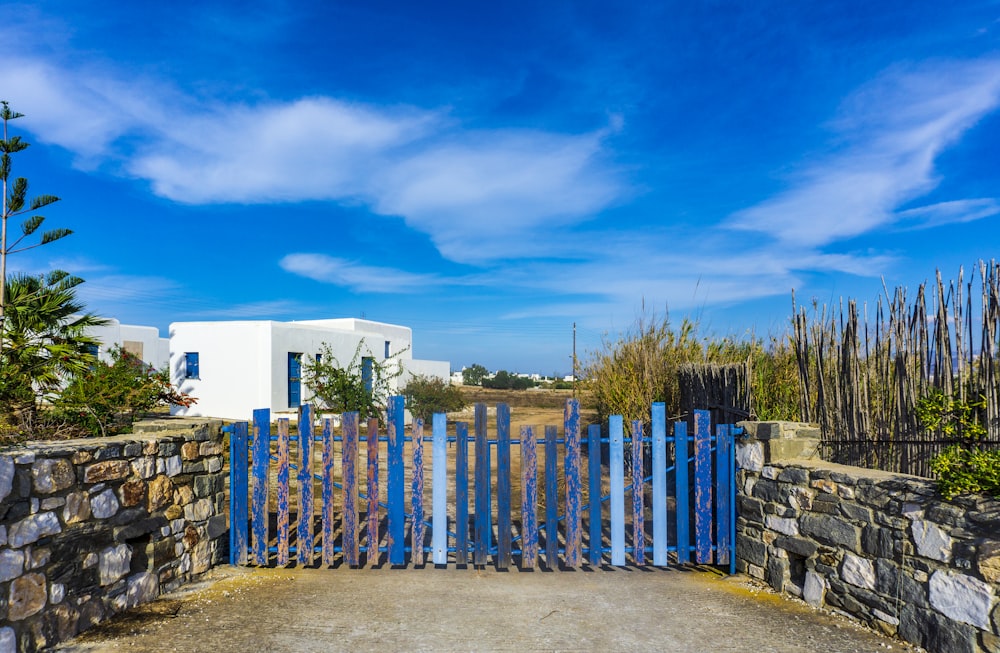 blue wooden gate under blue sky