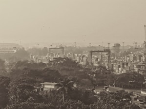 Industrial furniture and machinery being loaded into shipping containers at a port.