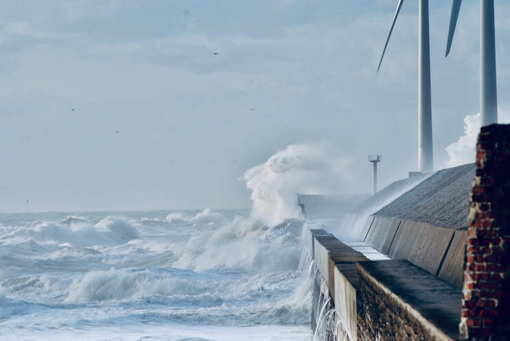 white wave sprays on dock