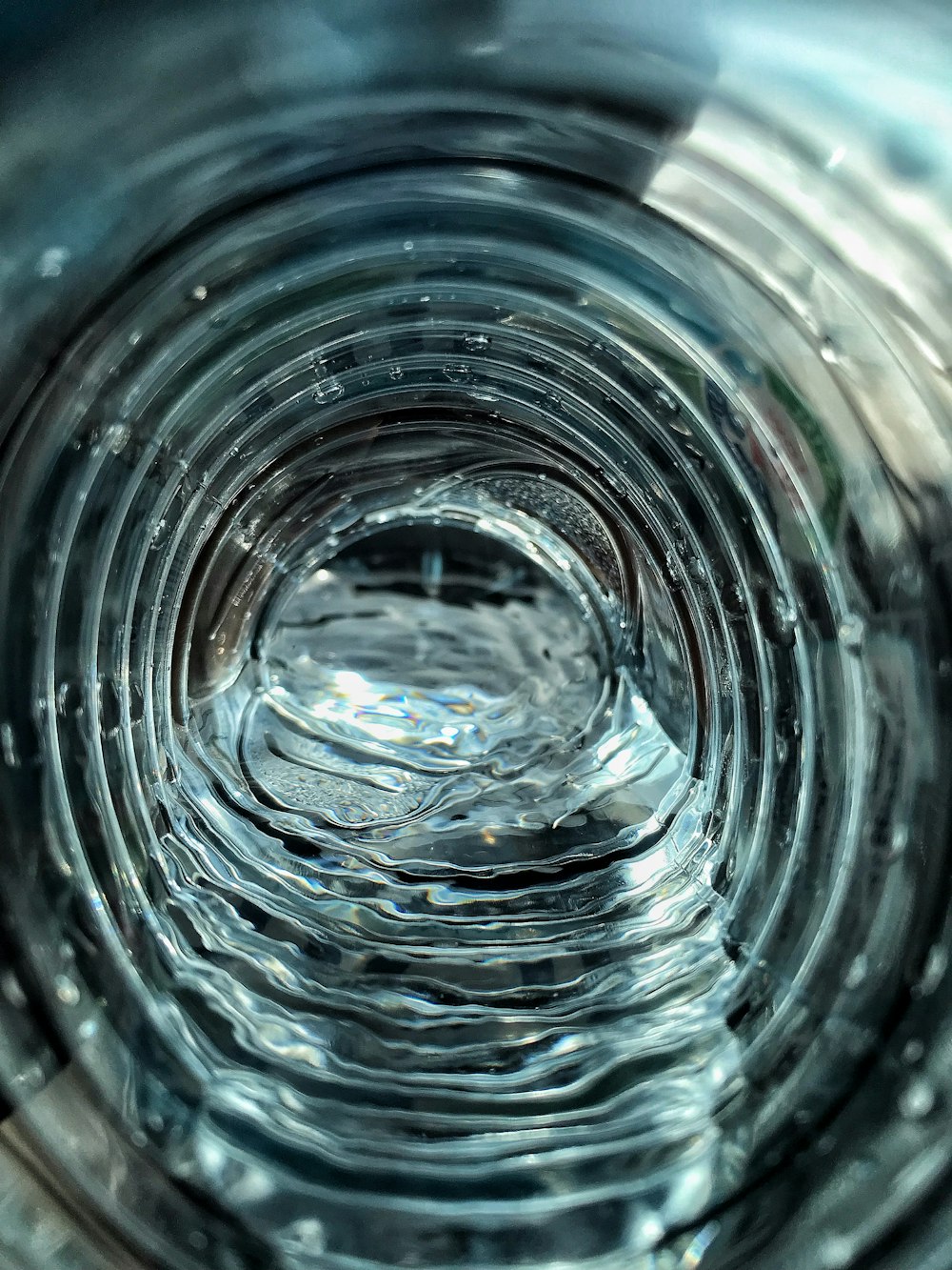 time lapse photography of rippling water inside clear plastic bottle