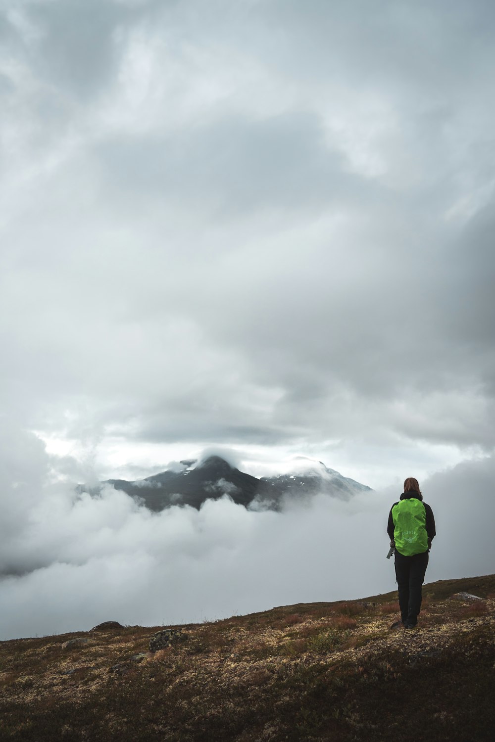 person standing in a mountain during daytime