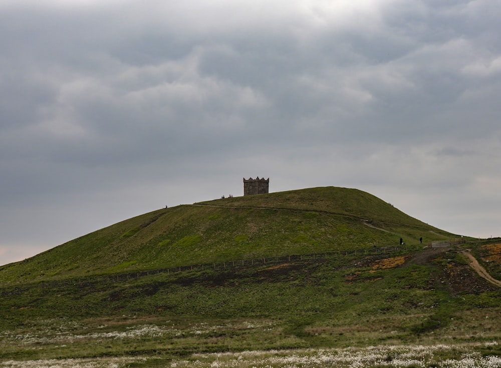 landscape photo of a castle on a green hill