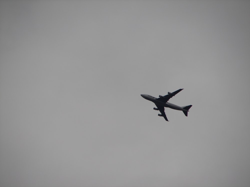grey passenger plane overhead