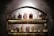 A rustic kitchen scene with jars of Rasakala products arranged on a wooden shelf.