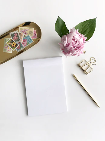 A neat arrangement of notary supplies, including a stamp and signed certificates on a wooden table.