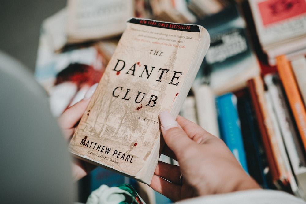 person holding The Dante Club book