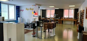 Wide shot of a commercial space featuring acoustic panels and digital prints on walls.