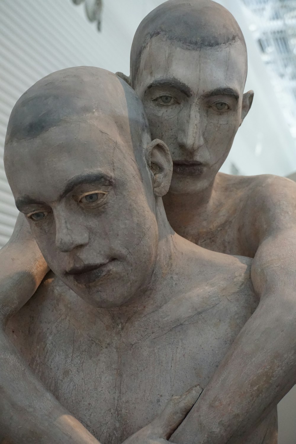 two men hugging statue
