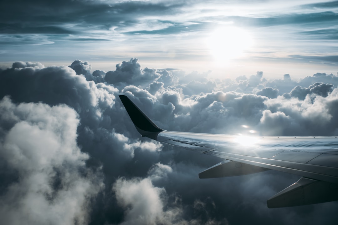 a view of the wing of an airplane in the sky, Sunset on a voyage<p></figure>
