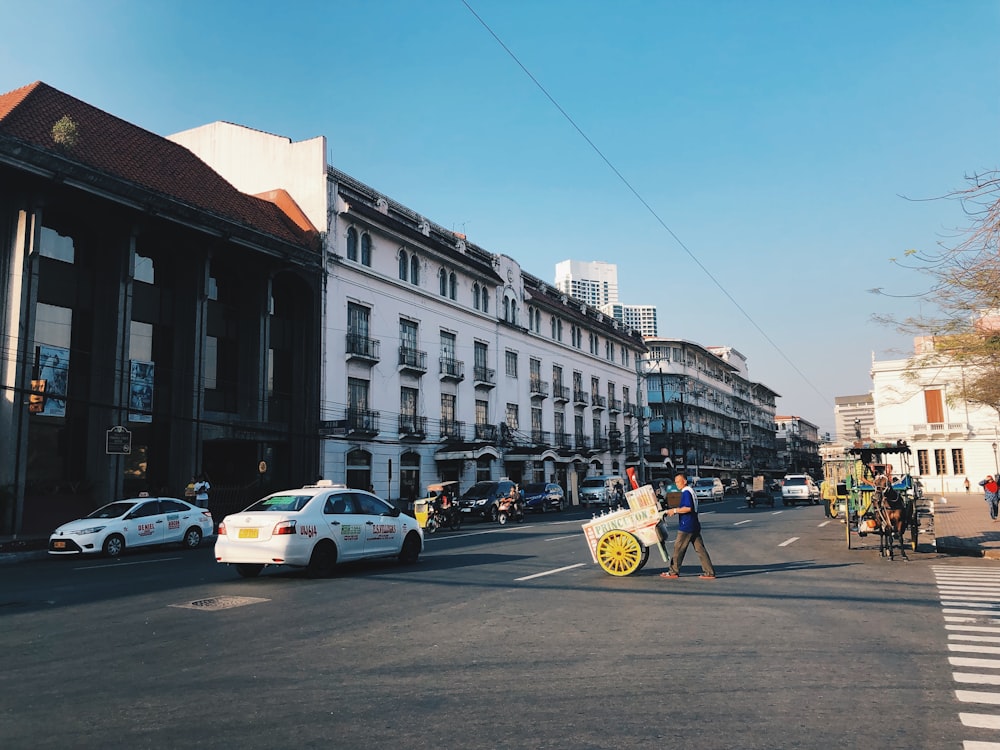 people and vehicle on the street near building