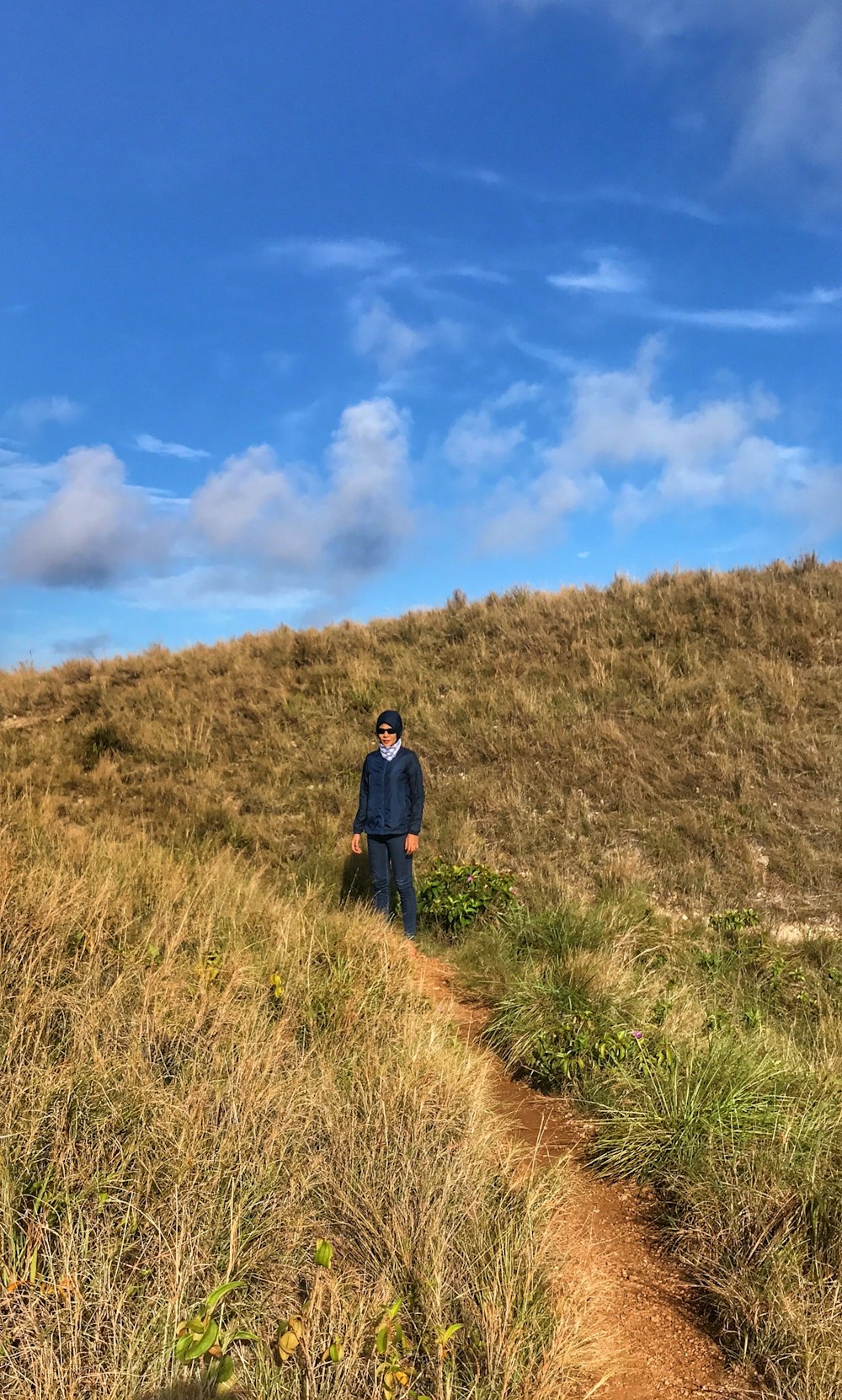 man standing beside grass