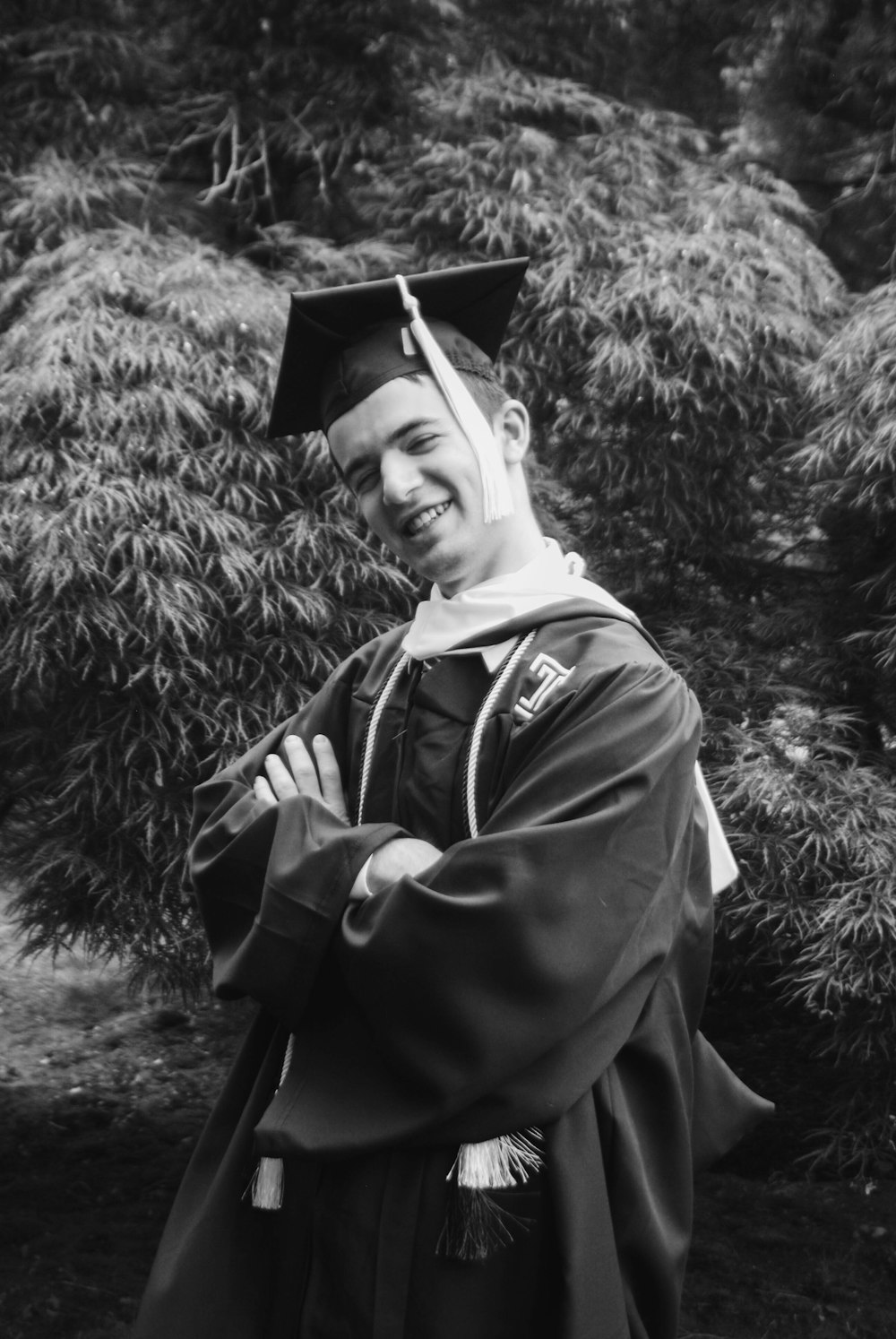 grayscale photography of man wearing academic dress