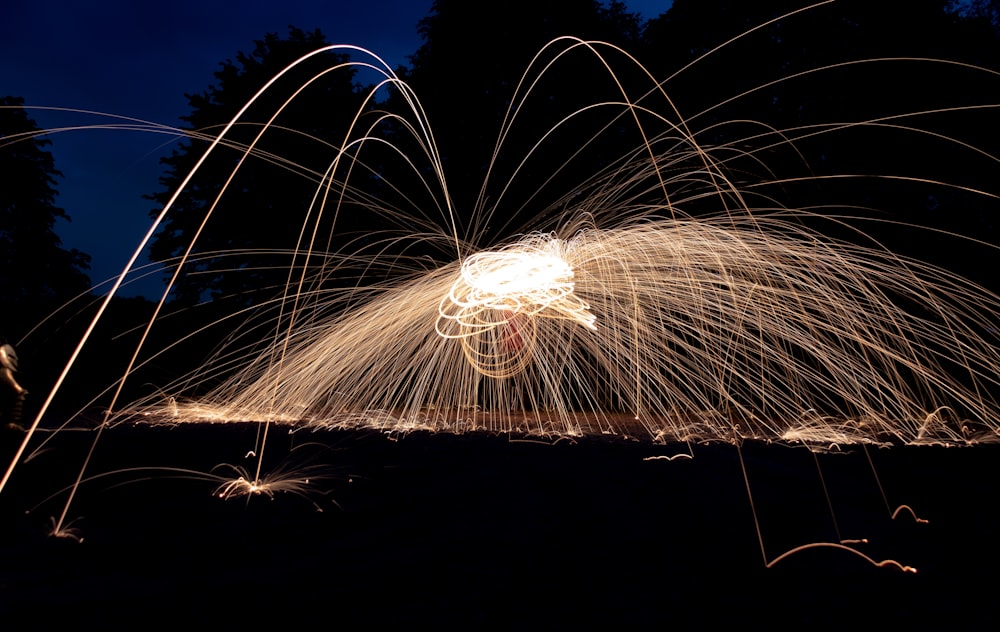 a long exposure photo of a firework display