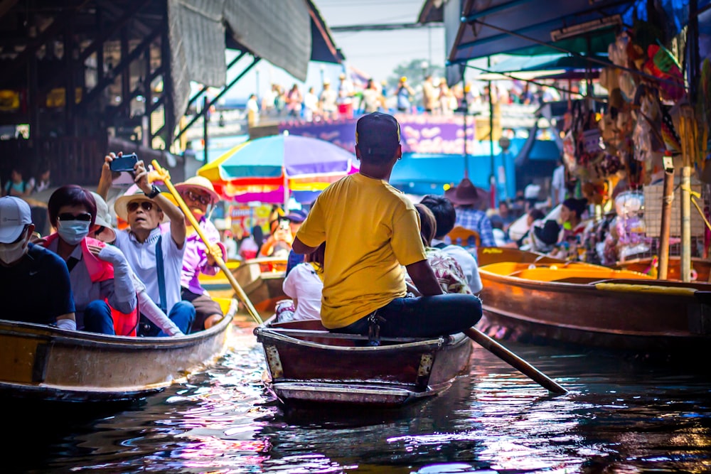 people riding on boat during daytime