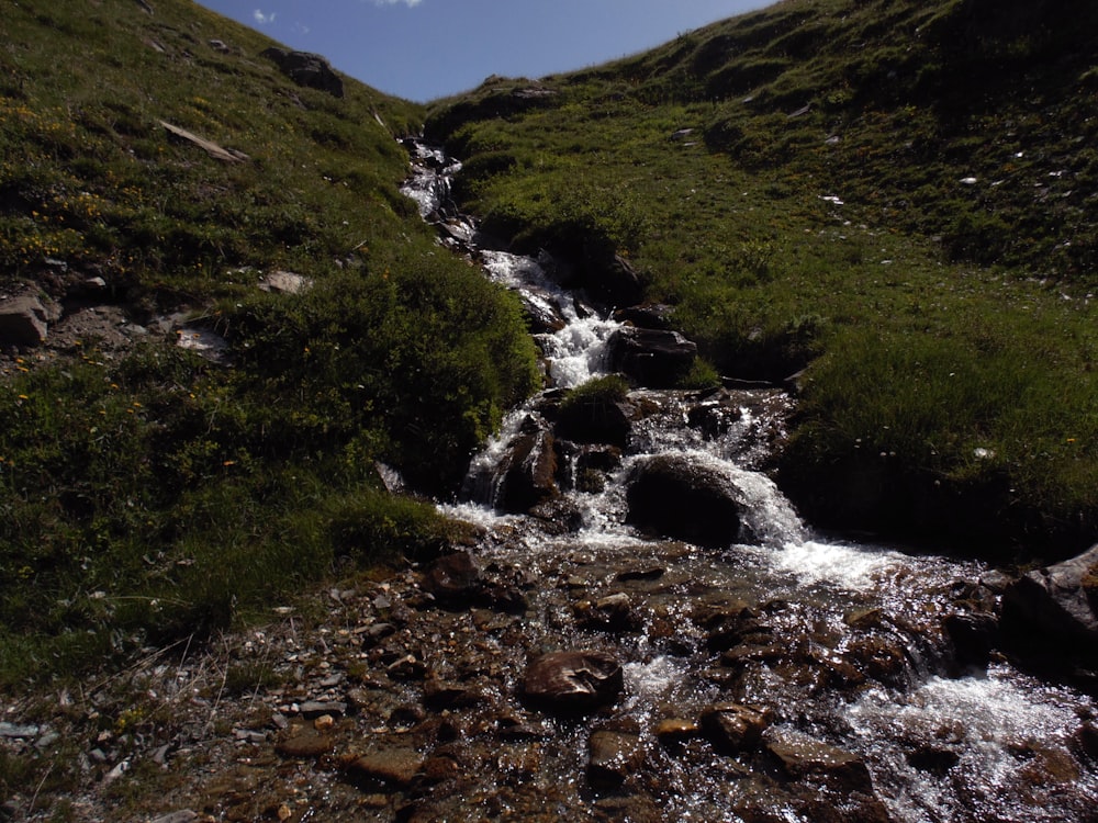 water walls from hill during daytime