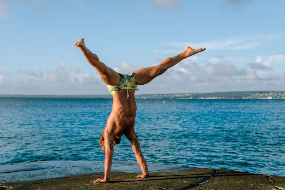 man standing using hands near sea