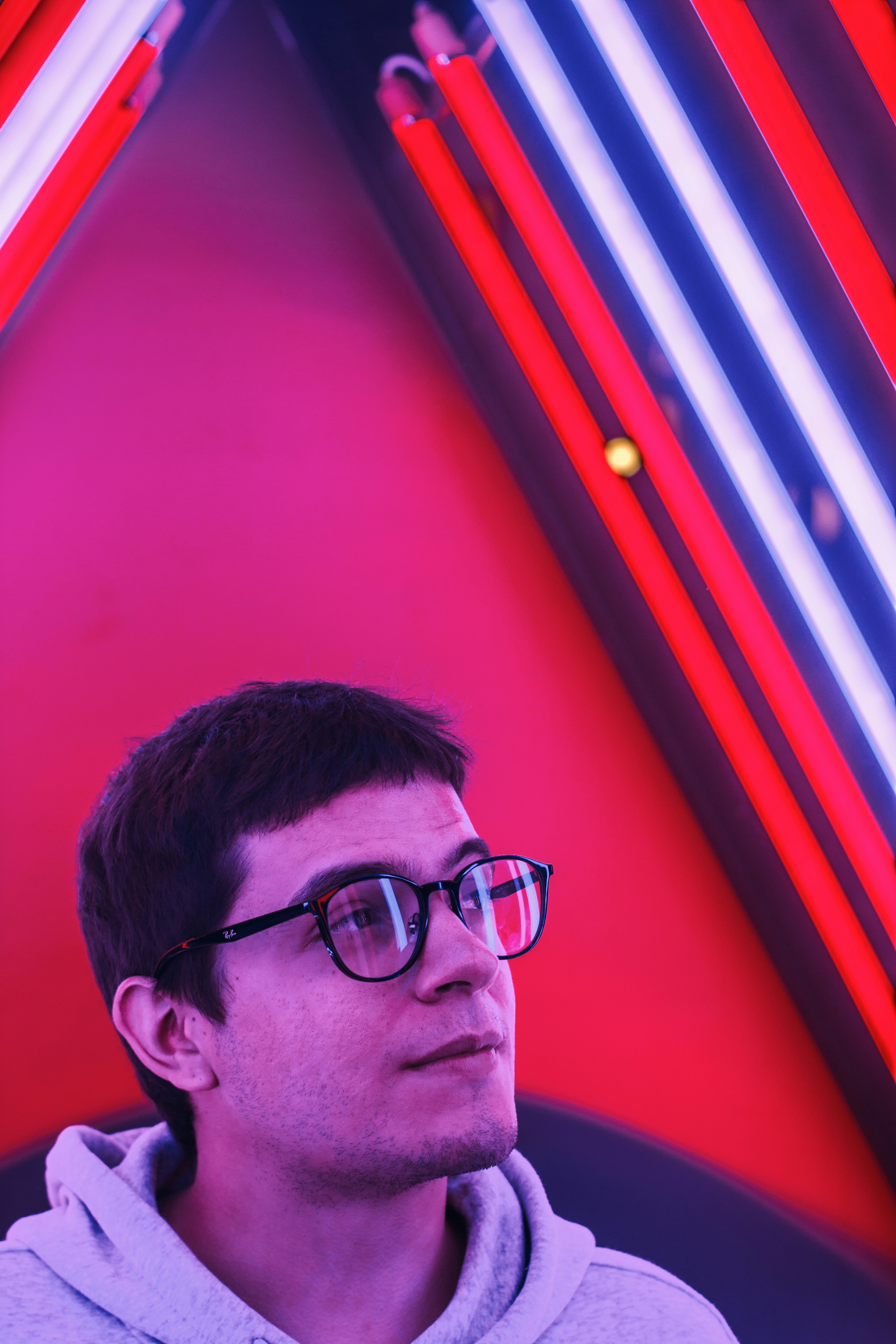man in grey hoodie sitting on sofa