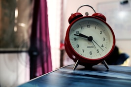 red framed alarm clock