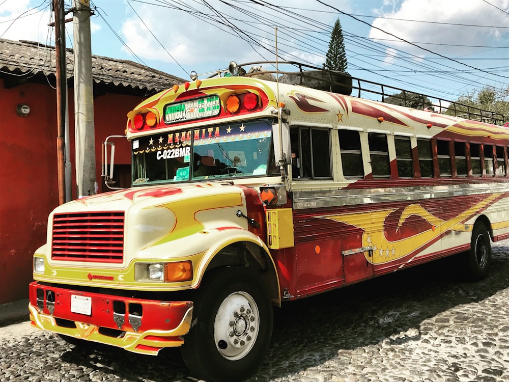 yellow and red bus near street post