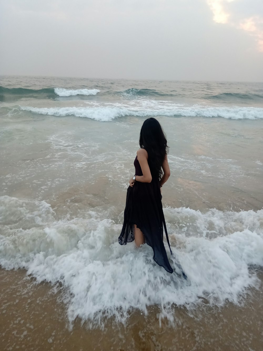 woman wearing black tank dress in beach