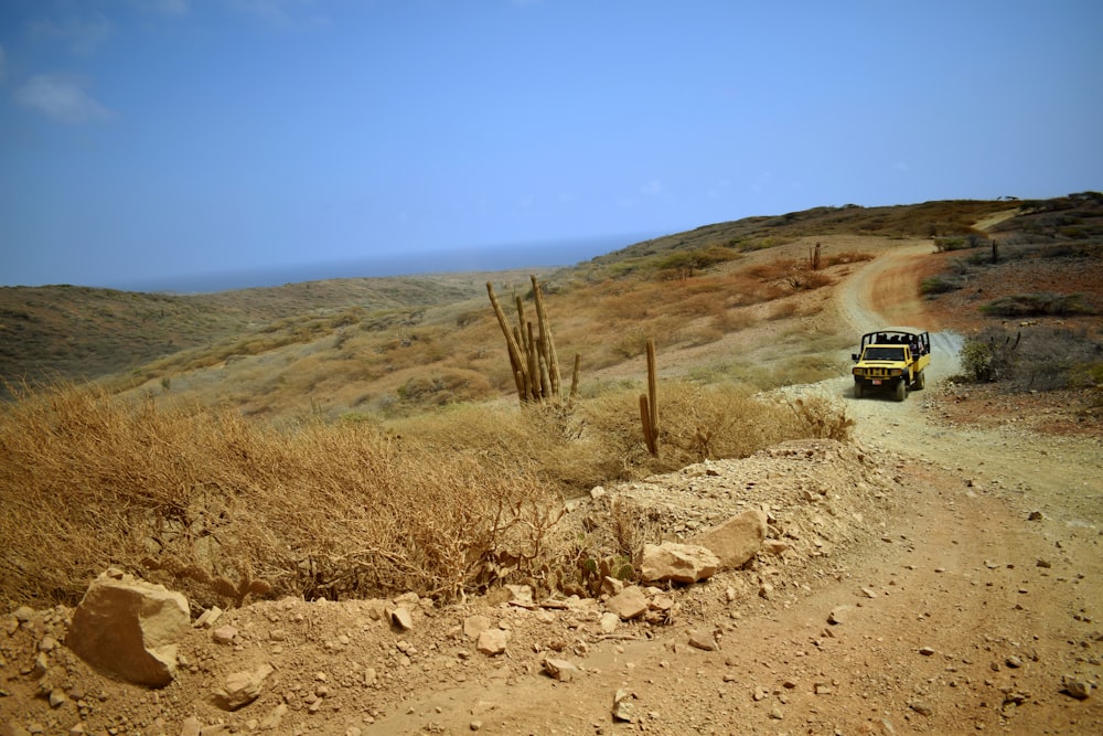 yellow vehicle running in road during daytime