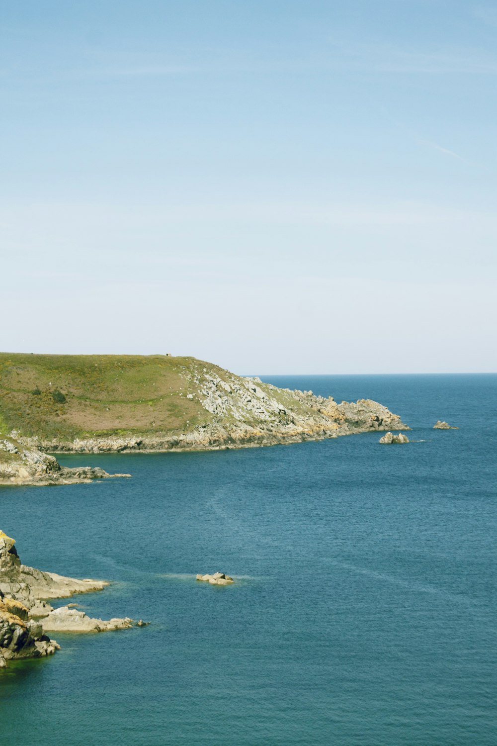 brown island and blue water