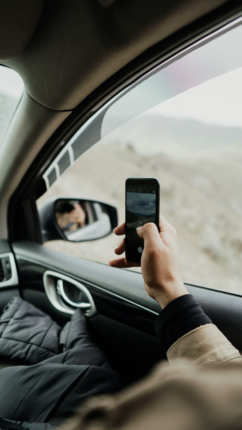 person using smartphone inside vehicle