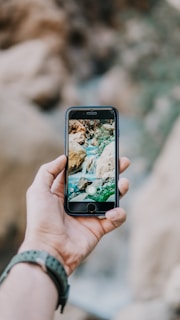 Close-up of a smartphone screen showing a photo with a custom watermark applied.