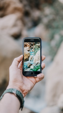 Close-up of a smartphone screen showing a photo with a custom watermark applied.