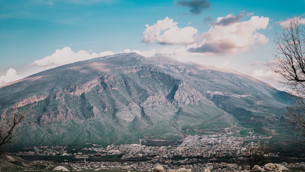 mountain under white clouds and blue sky during daytime