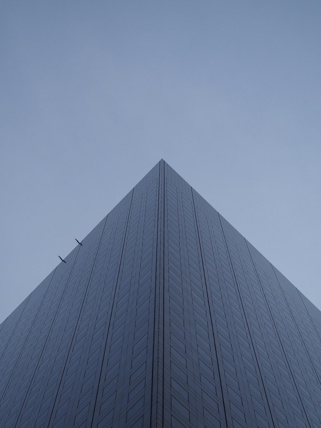 glass paneled high-rise building under grey sky