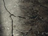 Close-up of a heavy-duty concrete cutter slicing through pavement.