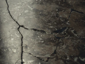Close-up of a heavy-duty concrete cutter slicing through pavement.
