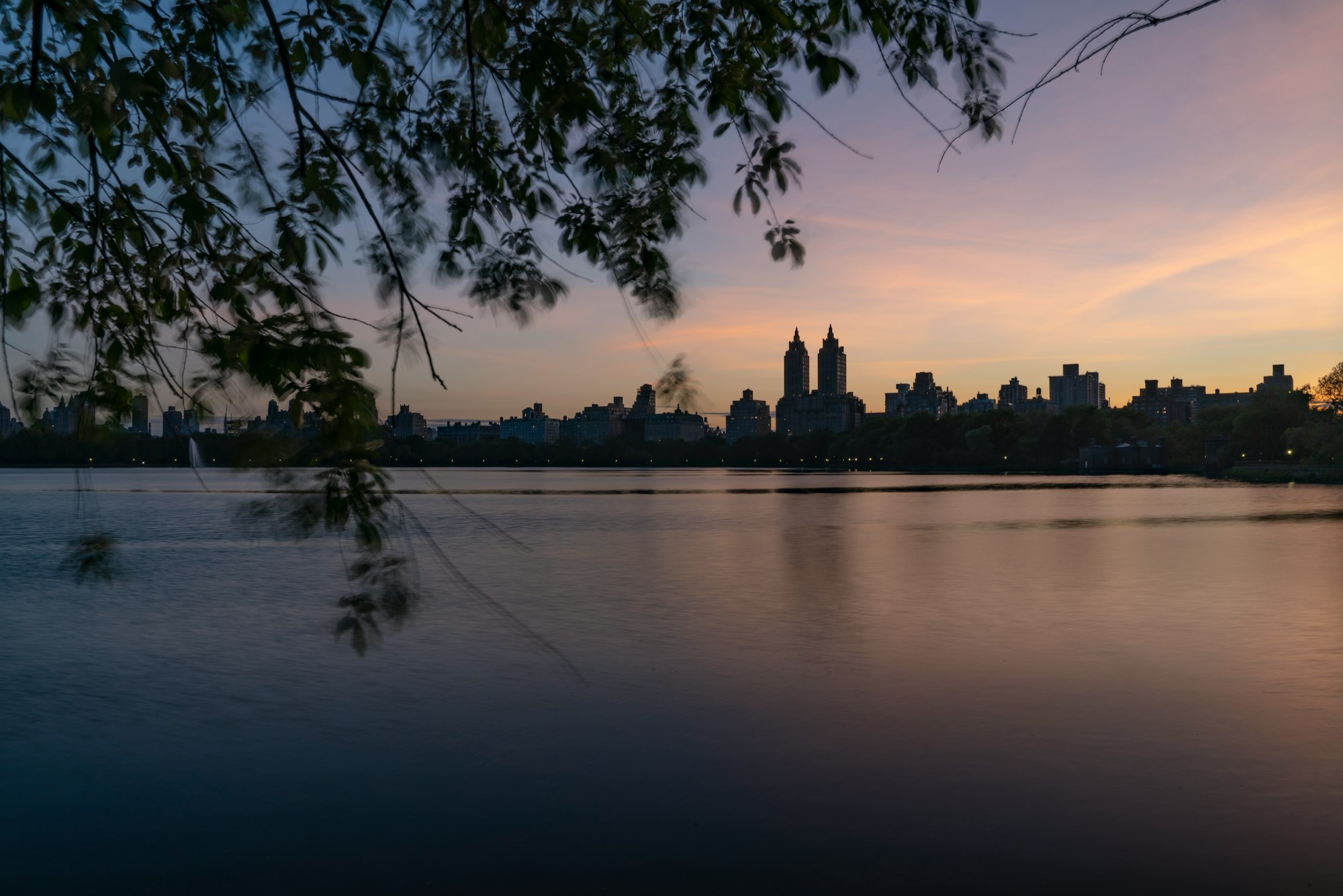 I took this photo from the east side of the Jacqueline Kennedy Onassis Reservoir in Central Park. The weather was warm but there was a slight breeze that I wanted to capture in the image, so I used a long exposure. This caught the movement of the leaves but also softened the water, making it a great reflection of the colors in the sky.