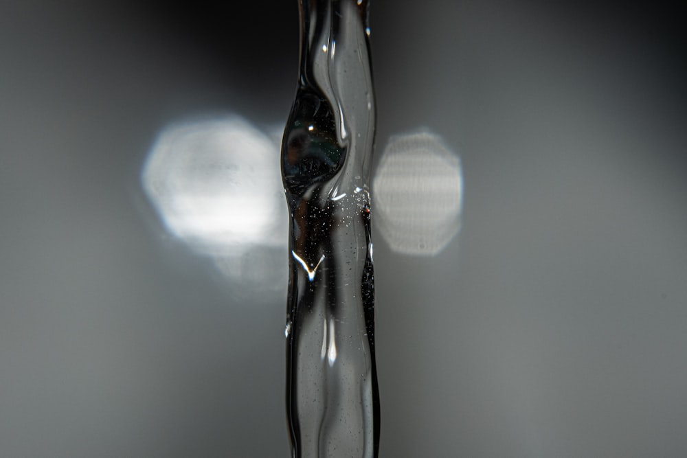 a close up of a water faucet with a blurry background