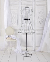 Tailored trousers and knitwear arranged to illustrate restrained, timeless style.