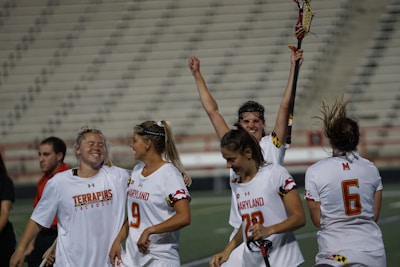 Celebration moment as the player raises her glove after a successful catch.