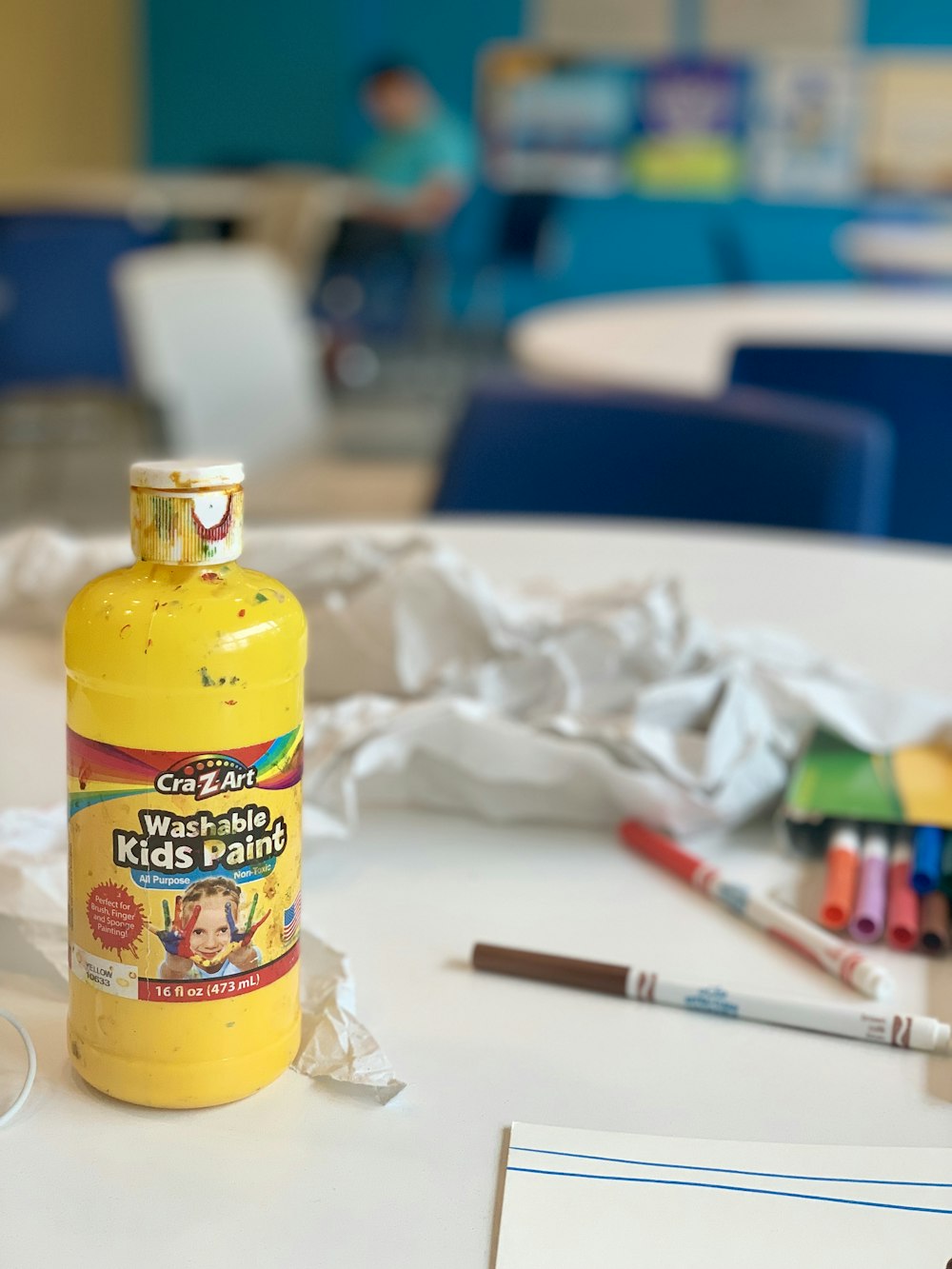 shallow focus photo of yellow Crazart kids paint bottle