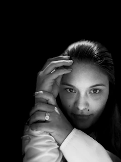 A minimalist portrait with subtle shading and expressive eyes, evoking quiet emotion.